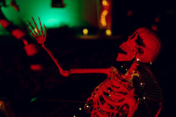 Night Halloween background. Halloween skeleton for decorated house. Scary decorated front yard of American house. Caricature or something. Halloween background. Autumn holiday of Halloween.