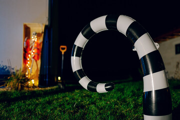 Night Halloween background. Halloween skeleton for decorated house. Scary decorated front yard of American house. Caricature or something. Halloween background. Autumn holiday of Halloween.