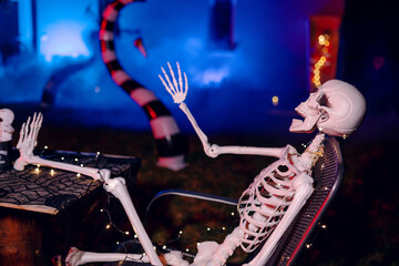 Night Halloween background. Halloween skeleton for decorated house. Scary decorated front yard of American house. Caricature or something. Halloween background. Autumn holiday of Halloween.