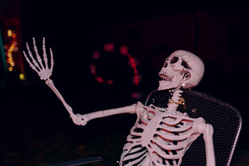 Night Halloween background. Halloween skeleton for decorated house. Scary decorated front yard of American house. Caricature or something. Halloween background. Autumn holiday of Halloween.