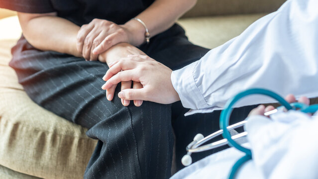 Arthritis hand and knee pain, joint injury or Osteoporosis bone disease patient with orthopedic surgical doctor consulting examining middle-age old menopause woman in medical clinic exam room - Powered by Adobe