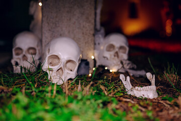 Night Halloween background. Halloween skeleton for decorated house. Scary decorated front yard of American house. Caricature or something. Halloween background. Autumn holiday of Halloween.