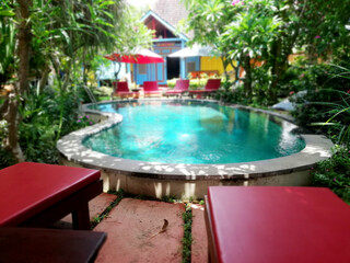 Swimming pool in the middle of the hotel area, with blurry background