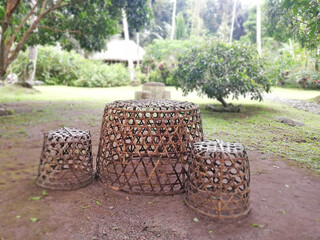Bamboo basket chair on the grass in the garden with natural background.