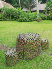 Bamboo basket chair on the grass in the garden with natural background.