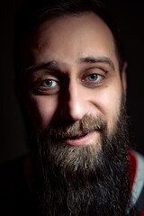 Close-Up Portrait of a Smiling Bearded Man with Expressive Eyes