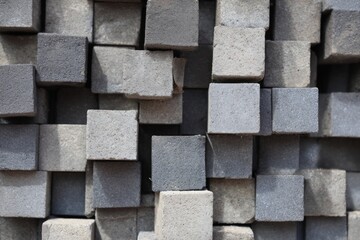 Stacked cement blocks in random pattern creating 3D texture composition
