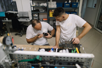 Two orthopedic specialists assembling artificial limb together