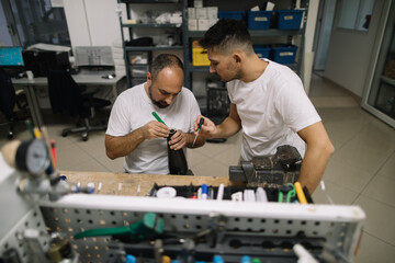 Two orthopedic specialists assembling artificial limb together