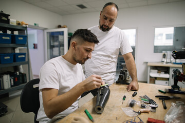 Orthopedic specialists assembling artificial limb together