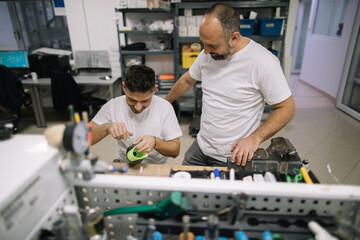 Orthopedic specialists assembling artificial limb together