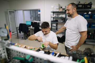 Coworkers working together in workshop