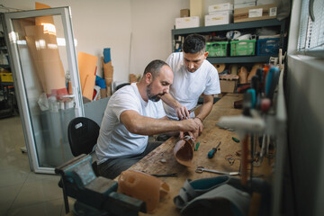 Orthopedic specialists assembling artificial limb together