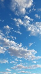 Naklejka premium Skyward Serenity: An awe-inspiring aerial perspective of a captivating, bright blue sky is adorned with fluffy clouds, invoking a sense of tranquility and limitless possibility.