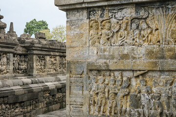 Detailed Buddhist relief art on Borobudur temple walls