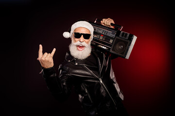 Rocking Santa with a vintage boombox wearing a leather jacket for a festive party vibe