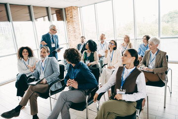 Diverse group of professionals participating in an engaging business workshop in a modern office environment