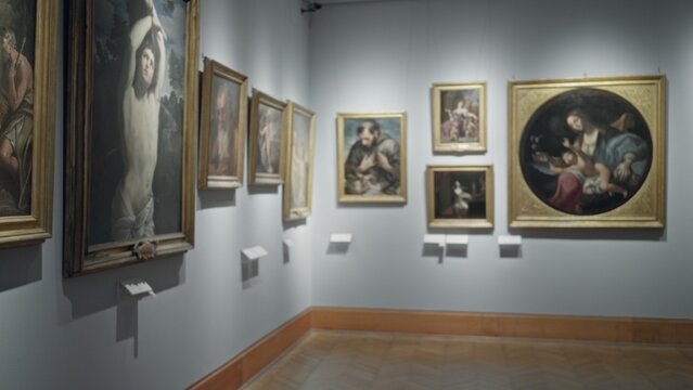 Soft blurred museum gallery wall with framed paintings and labels, shallow defocused focus conveying empty exhibit corridor; background backdrop copyspace calm. - Powered by Adobe