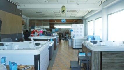 Blurred spa showroom with defocused hot tubs and display aisles, shallow depth of field shop; background backplate copyspace calm.