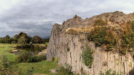 view of the landmark Panska Skala basalt column rock formation in the north of the Czech Republic