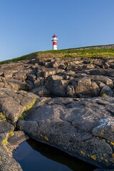 vertical view of the Torshavn Lighthouse at the Skansin Fortress on the Faeroe Islands at sunrise