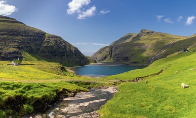 view of the historic sod-roof Lutheran church in Saksun and Pollurin Lagoon