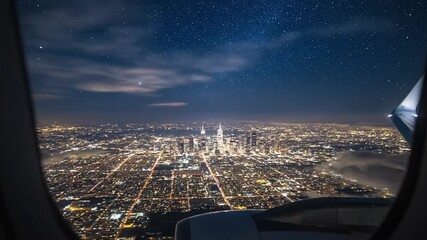 Aerial view of city skyline at night from airplane window   - Powered by Adobe