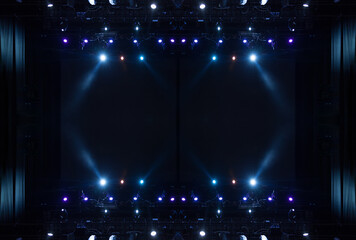 An empty stage of the theater, lit by spotlights and smoke before the performance