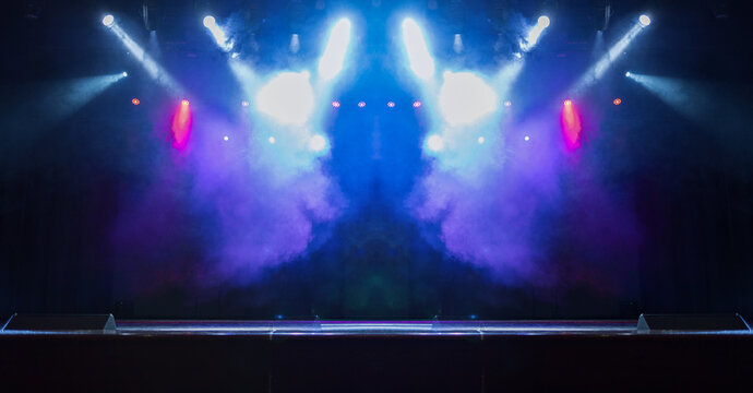 Spotlights in the concert hall. Stage light with colored spotlights and smoke.