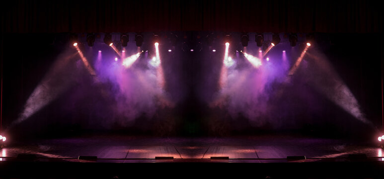 Spotlights in the concert hall. Stage light with colored spotlights and smoke.