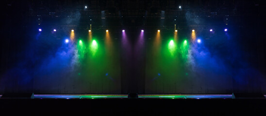 Spotlights in the concert hall. Stage light with colored spotlights and smoke.