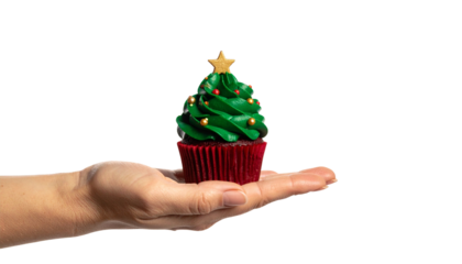 A festive Christmas tree cupcake on a person's open palm