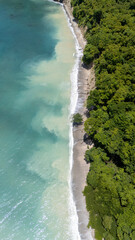 drone shot of tropical beach with blue water
