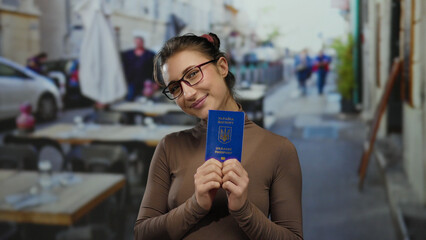 Woman holding ukrainian passport on outdoor restaurant terrace showcasing travel readiness and...