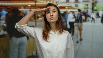 Woman saluting in a bustling outdoor city market with diverse shoppers showcasing an urban lifestyle and vibrant street scene.