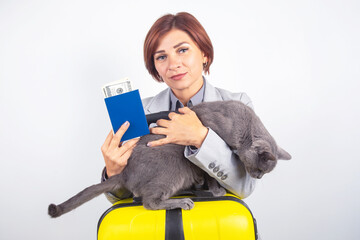 Woman holding passport and money with cat on suitcase ready for travel