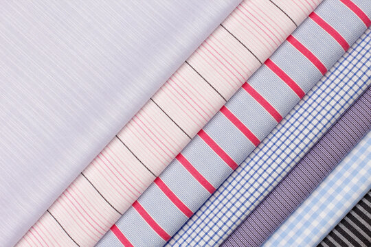 Variety of colorful fabrics displayed in a textile store for fashion design enthusiasts