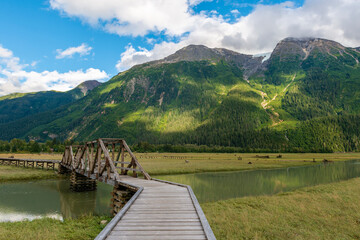 Coastal Mountains of the Pacific Range with the estuary boardwalk for bird watching, Stewart, British Columbia, Canada.