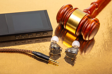 Legal tools and technology combined on a reflective surface with audio equipment