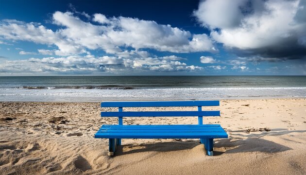 blue bench on sandy beach cloudy sky
