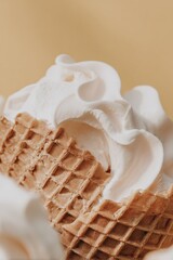 Horizontal view of a light waffle cone lying on its side with vanilla ice cream