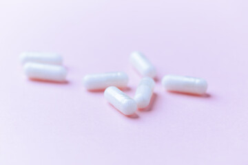 Carnitine capsules on paper background. Soft focus. Close up. Copy space.	