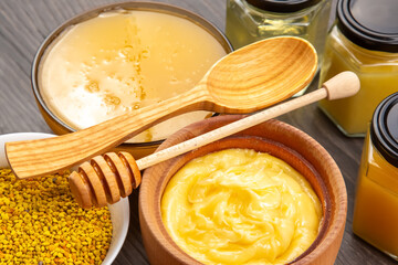 Collection of honey, bee pollen, and natural wax displayed on a wooden table
