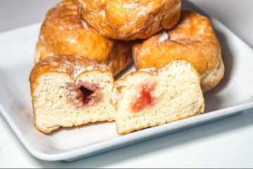 some tasty jam doughnuts on a plate