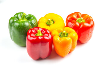 Colorful assortment of bell peppers on white background showcasing vibrant shades