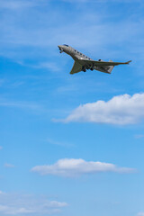 Private jet gracefully taking off into blue sky