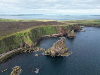 Obraz premium Drone View of the Duncansby Sea Stacks and wild and rugged coastline of Caithness in the Scottish Highlands