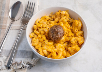 macaroni and cheese  with an italoan style meatball