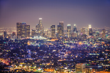 Close panoramic night view of Los Angeles city skyline from Griffith Observatory, vibrant urban lights, modern architecture, glowing downtown buildings, twilight sky, travel destination, California US