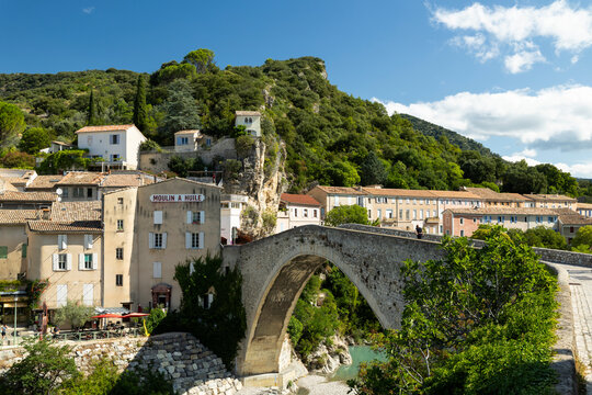Nyons Roman bridge spanning Eygues river with village houses